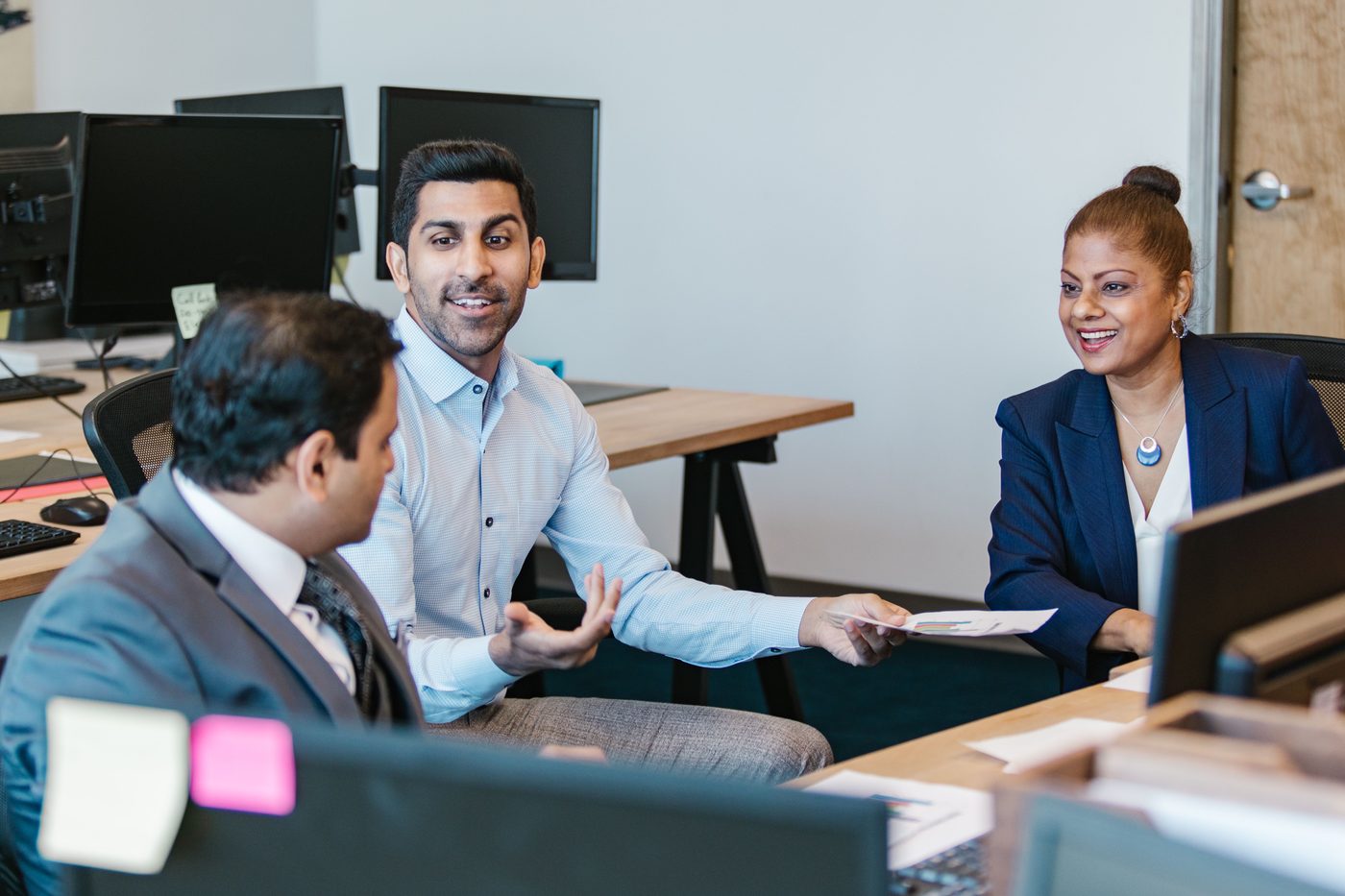 An advisor presenting plan figures to a leadership team