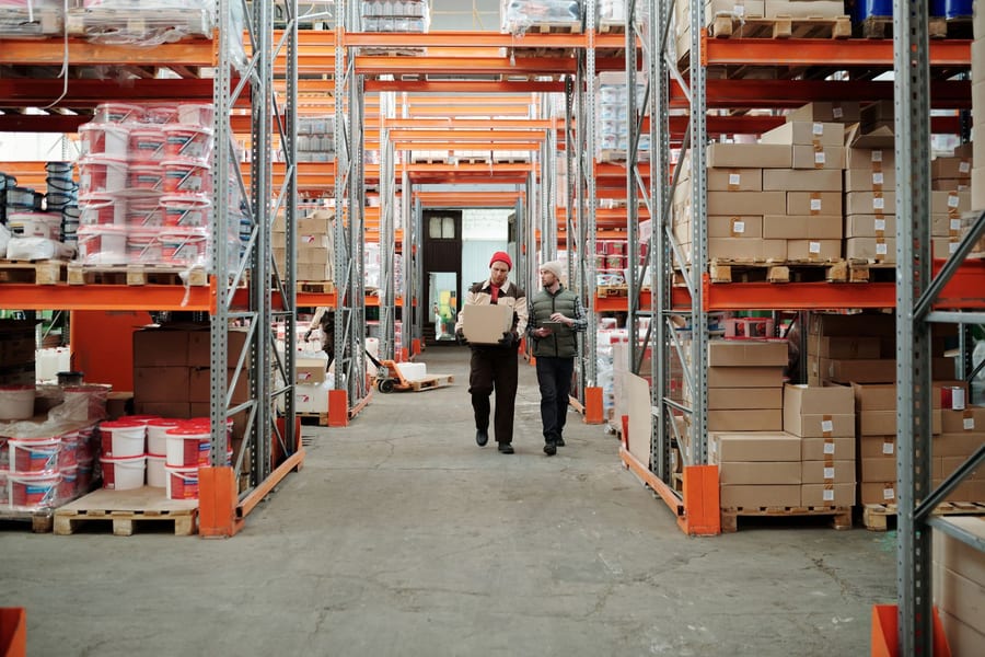 Warehouse staff at work in a manufacturing aisle